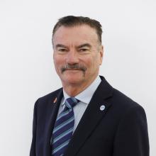 Man smiling and wearing a suit